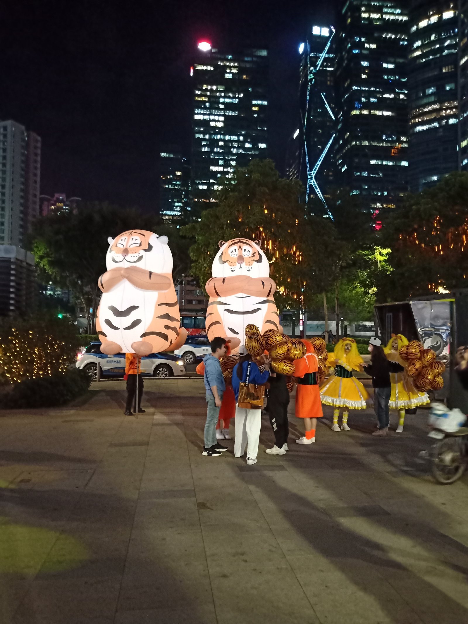 Two large illuminated tiger inflatables installed at an evening public event.
