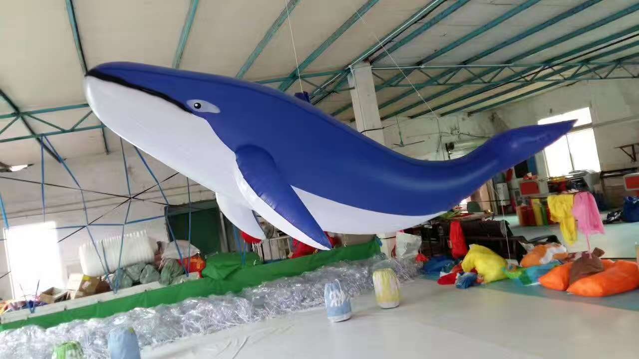 Large blue whale inflatable suspended during a factory test.